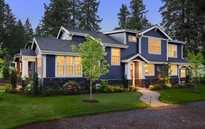 Vibrant home exterior with new energy-efficient windows glowing at twilight.