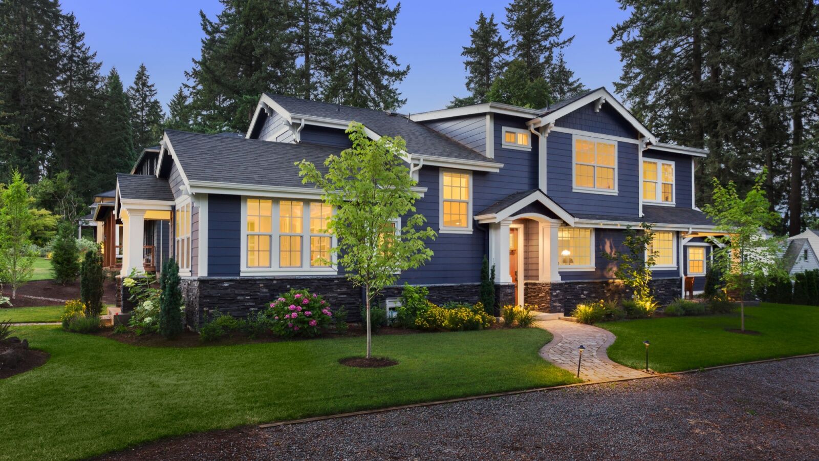 Vibrant home exterior with new energy-efficient windows glowing at twilight.