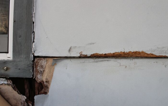 Rotting exterior window trim and lap siding in Richmond, VA.