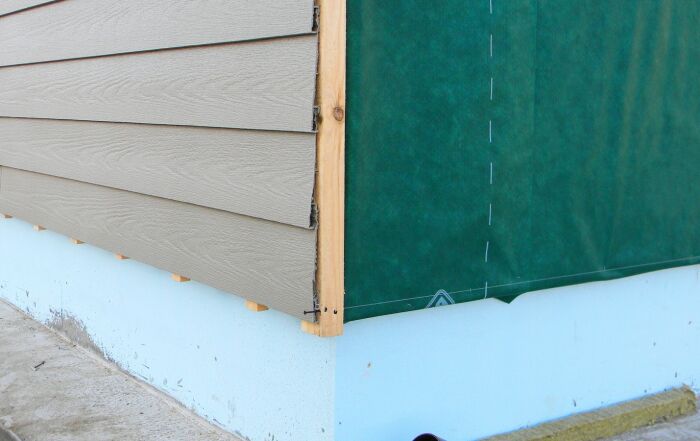 Insulated siding membrane exposed during installation.