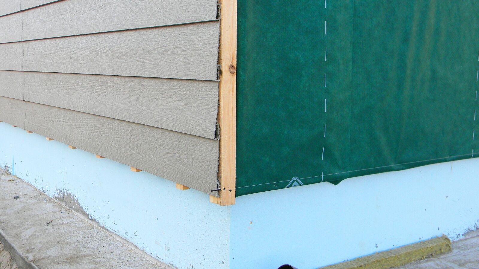 Insulated siding membrane exposed during installation.